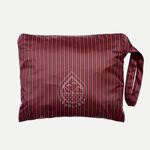 Red VeðurRó rain poncho packed into its carrying pouch